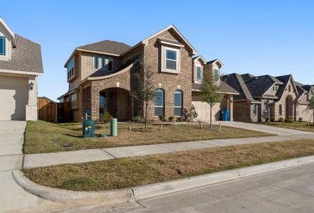 View of front of home with a garage and a front yard