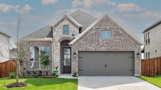 View of front of property featuring a garage and a front yard