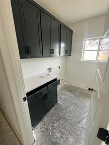 Laundry room featuring washer hookup, electric dryer hookup, and cabinets
