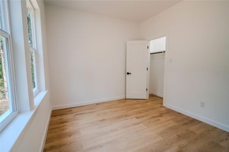 Unfurnished room with plenty of natural light and light hardwood / wood-style floors