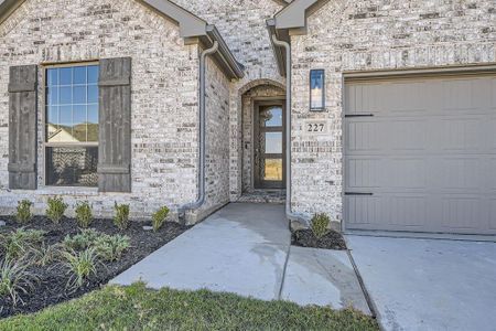 View of exterior entry featuring a garage