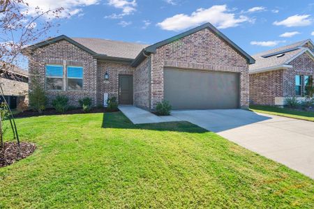 View of front of home with a front yard and a garage