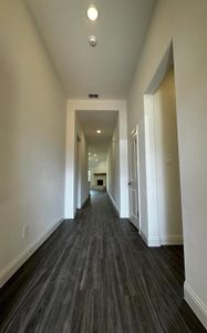 Corridor featuring dark wood-type flooring