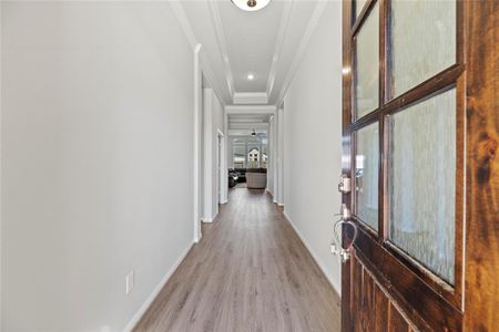 Tall ceilings and beautiful luxury vinyl flooring invite you into the foyer