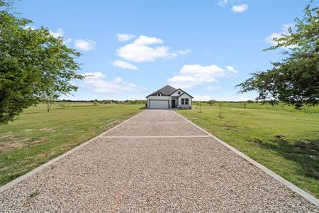 View of home's community with a yard and a rural view