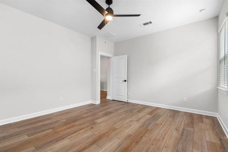 In the primary bedroom, vinyl plank flooring creates a foundation of modern elegance, while a ceiling fan provides a soothing breeze on warm nights.