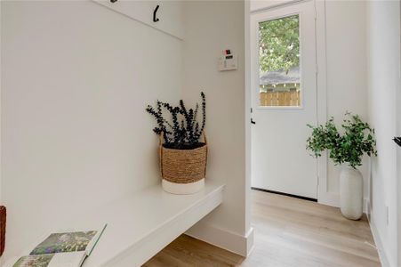 Upon entering there is a convenient mud room with built-in bench and hooks.