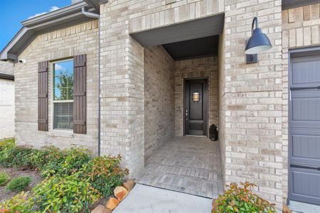 Upgraded brick entry and mahogany door are a few of the lovely features. Window shutters and beautiful exterior lighting.