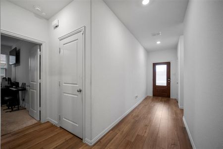 Hallway featuring hardwood / wood-style flooring and a healthy amount of sunlight