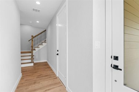 A view of your entryway that unveils small details of your new home inviting exploration with hints of architectural design throughout the home.