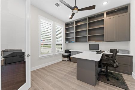 This elegant study is ideal for a home office or library, featuring custom-built cabinets that provide ample storage for books, files, or décor.