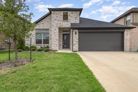 View of front of home with a garage and a front yard