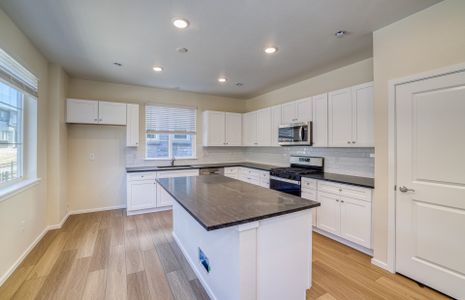 Stunning Kitchen with crisp white cabinets and black granite counters