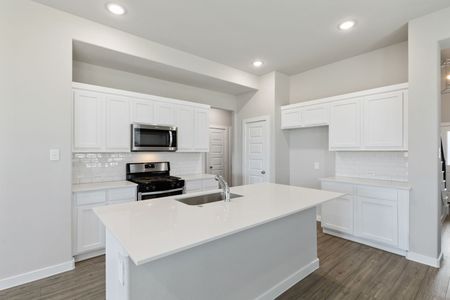 Kitchen in the Elm home plan by Trophy Signature Homes – REPRESENTATIVE PHOTO