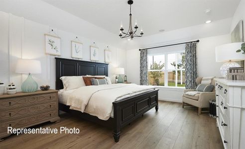 Bedroom with an inviting chandelier and hardwood / wood-style floors