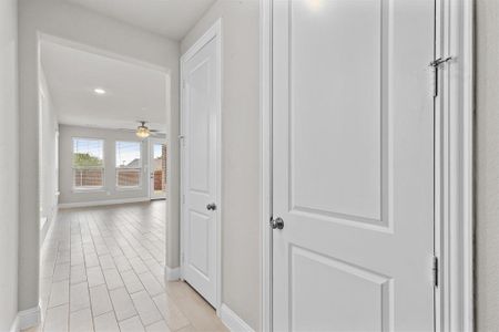 Hall featuring light tile patterned flooring