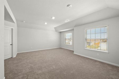 Large, primary bedroom with beautiful windows.