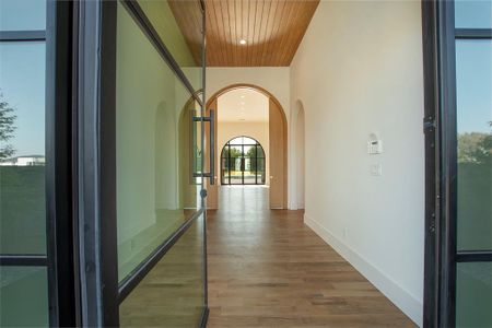 Corridor with wooden ceiling and hardwood / wood-style floors