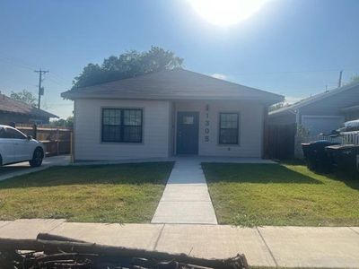 View of front of property with covered porch and a front lawn