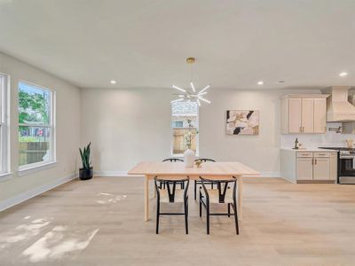 Dining space with an inviting chandelier and light wood-type flooring