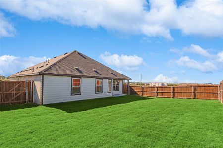 Rear view of house with a yard