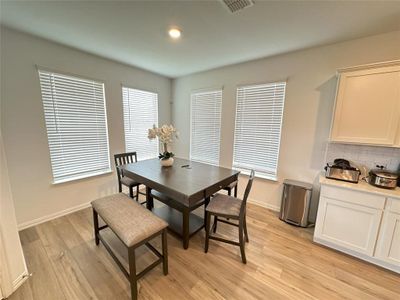 Dining area with light wood-type flooring