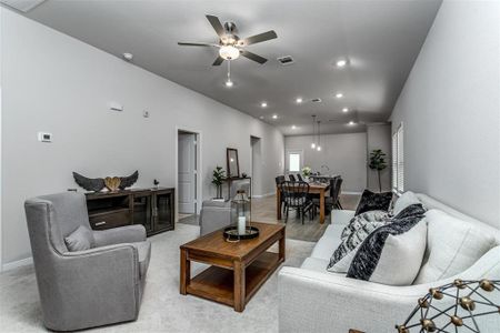 The heart of the home, this expansive living room is designed for both comfort and style. Recessed lighting, neutral tones, and modern finishes make this space perfect for cozy evenings or hosting friends. Open to the dining area and kitchen, this space promotes a connected, airy atmosphere. **This image is from another Saratoga Home - Mockingbird floorplan.**