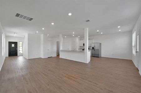 The view from the family room to the kitchen, breakfast area, half bath and laundry room. Spacious!