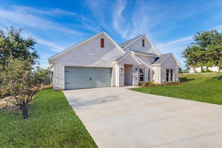 View of front of home featuring a garage and a front yard