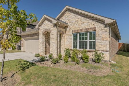 View of front facade featuring a front lawn and a garage