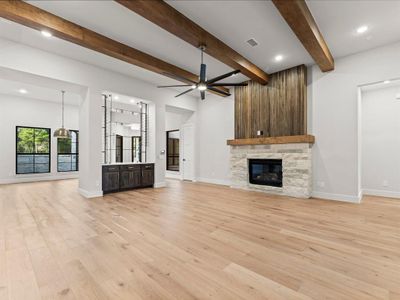 Family Room with Gas-Log Fireplace, Engineered Hardwood Flooring, and Modern Fan