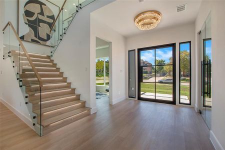 Entrance foyer with a notable chandelier and hardwood / wood-style flooring