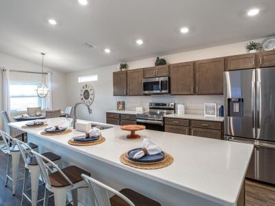 Enjoy a sunny, open kitchen with quartz counters, 36-inch cabinets, and Samsung appliances.