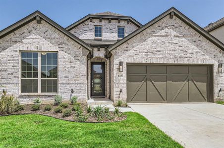 View of front of property with a garage and a front yard