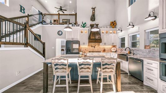 This kitchen has so many upgrades with smart GE Cafe appliances, gas cooktop with a pot filler, & a spacious island with under island cabinets for all your seasonal dishes.