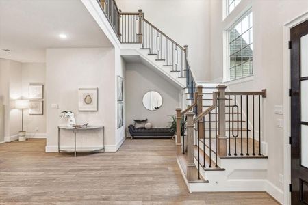 Make a statement with the impressive foyer of this custom-built residence, featuring stunning wood floors and a fresh, neutral palette. There is also convenient storage underneath the stairs.