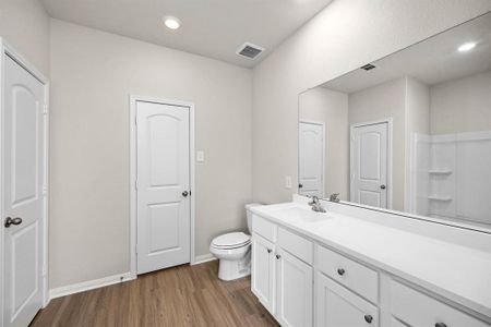Luxurious primary bathroom with a walk-in closet.