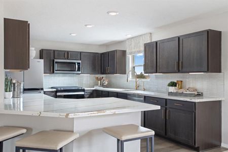 This stunning kitchen displays such a beautiful contrast with the dark stained cabinets, custom neutral paint, silestone countertops, light modern backsplash, and SS appliances including microwave and refrigerator, extended countertop for breakfast bar, recessed lighting, high ceilings, and walk in pantry!