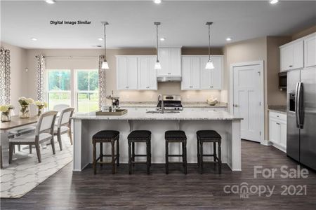 Spacious kitchen with large island, eating area, and walk-in pantry