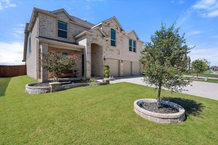 Side view of front of property featuring a front yard and a garage