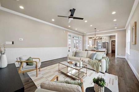 Step into the open plan Living - Dining - Kitchen spaces! The wainscoting detail continues into this space. SOLID HICKORY hardwood floors throughout!