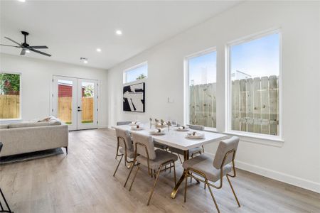 Windows thoughtfully placed around the living area flood the space with natural light, enhancing the open and airy atmosphere