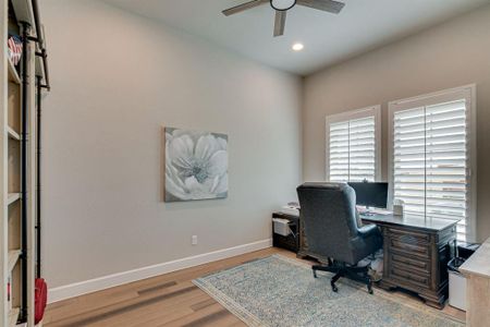 Home office featuring ceiling fan and hardwood flooring
