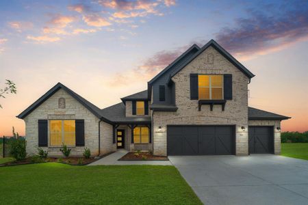 View of front of house featuring a lawn and a garage