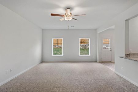 Carpeted living room with ceiling fan