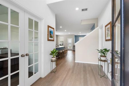 Enter into a grand two-story foyer.  The home office is to your left and entrance from the garage and guest half bath are on the right.