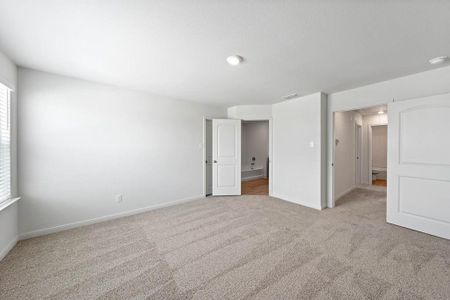 Bedroom with light colored carpet