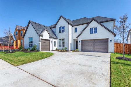 View of front facade with a front yard and a garage