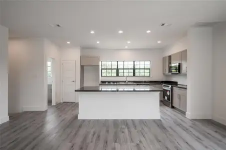 This Kitchen features a central island and ample natural light from large windows.