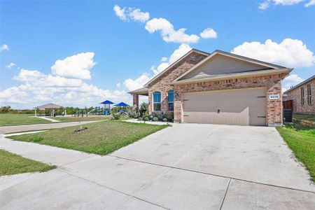 View of front of property with a front lawn and a garage